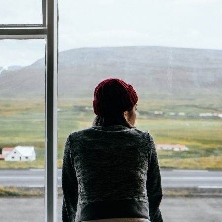 woman standing on glass window